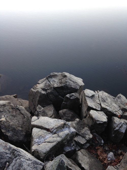 A space-like image of some rocks over a still lake