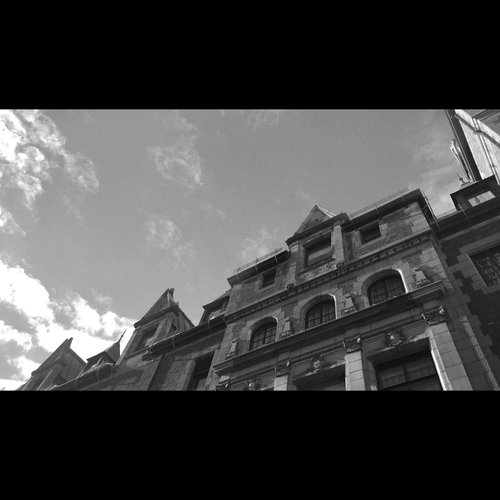 A cinematic black and white landscape from inside the Quebec city chateau courtyard 